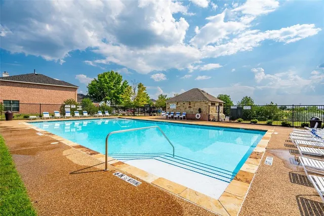 a view of a lake with a table and chairs