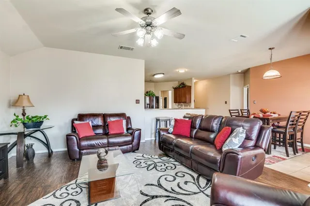 a living room with furniture a rug and a chandelier