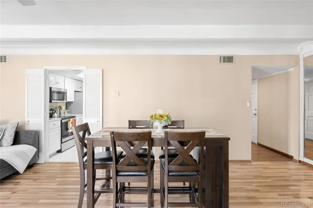 a view of a dining room with furniture and wooden floor