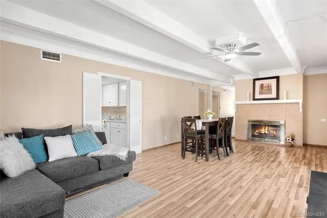 a living room with furniture a fireplace and a table