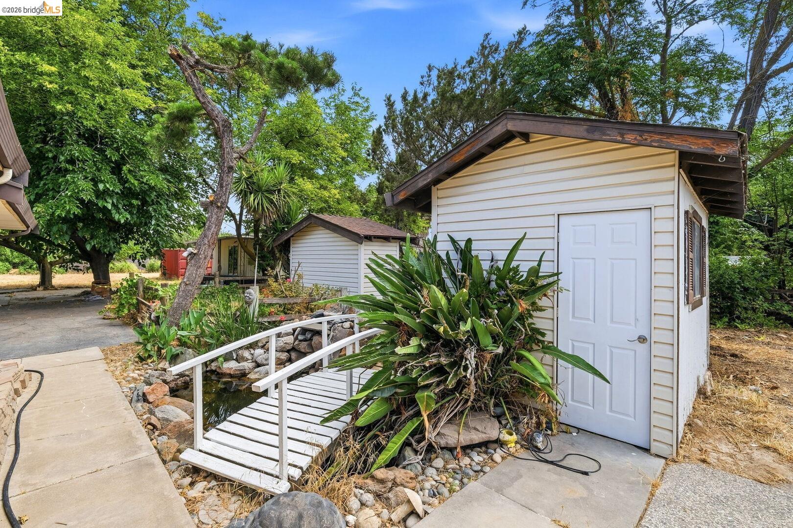 1590 Sunset Road Brentwood, CA 94513 - Photo 34 of 45 Detached shed with vinyl siding, a paneled door, and an exterior window