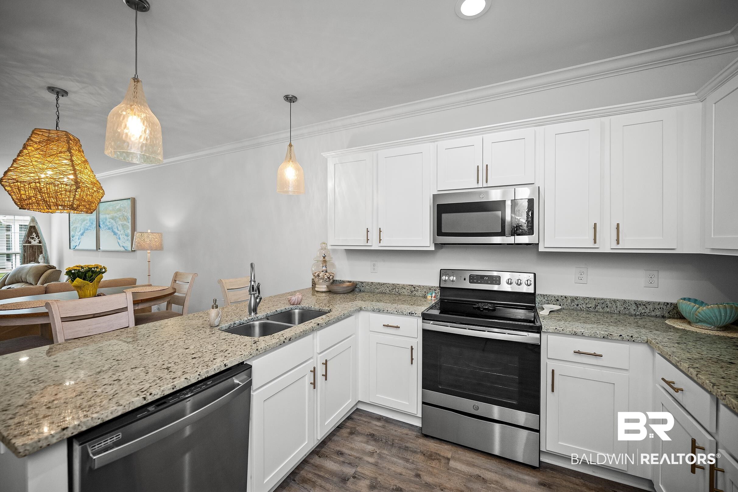 2651 South Juniper Street, Unit 2002 Foley, AL 36535 - Photo 5 of 23 Modern kitchen featuring white cabinetry, granite countertops, stainless steel appliances, wood-finish flooring, and recessed lighting