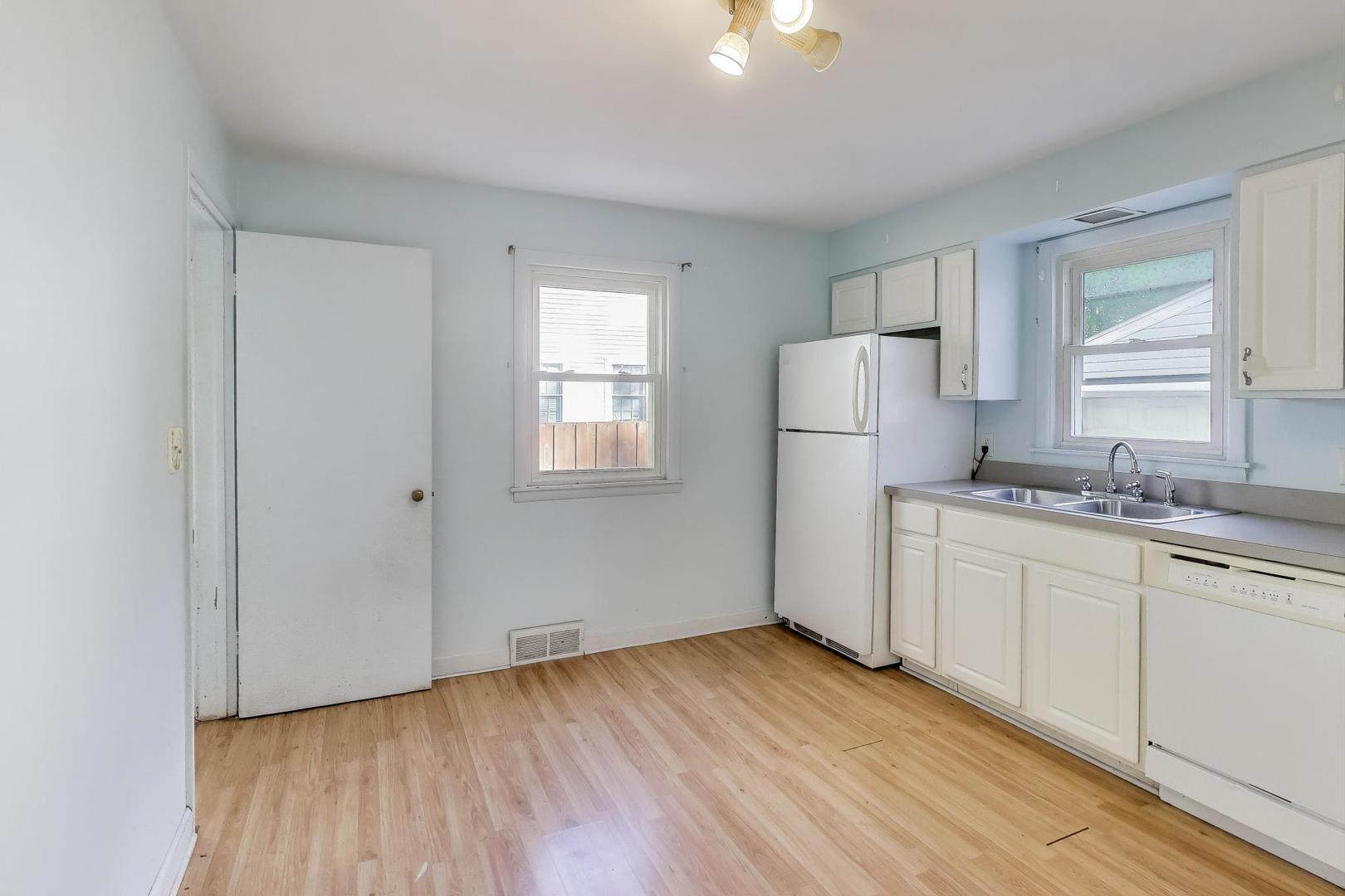 221 Heine Avenue Elgin, IL 60123 - Photo 12 of 43 a kitchen with a refrigerator and window