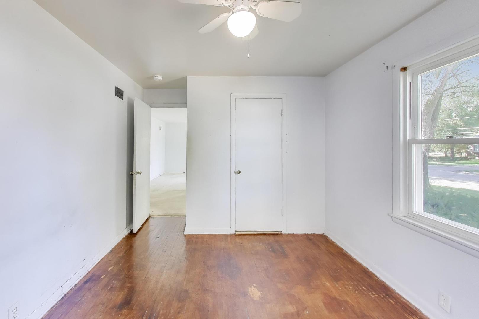 221 Heine Avenue Elgin, IL 60123 - Photo 17 of 43 an empty room with wooden floor and windows