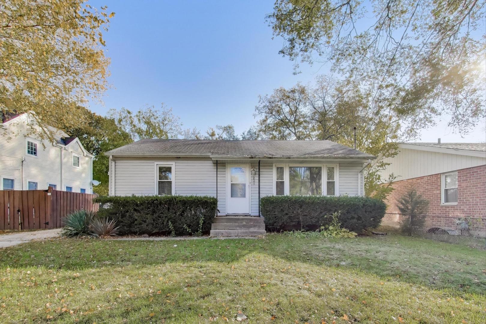 221 Heine Avenue Elgin, IL 60123 - Photo 2 of 43 a front view of a house with a yard and garage