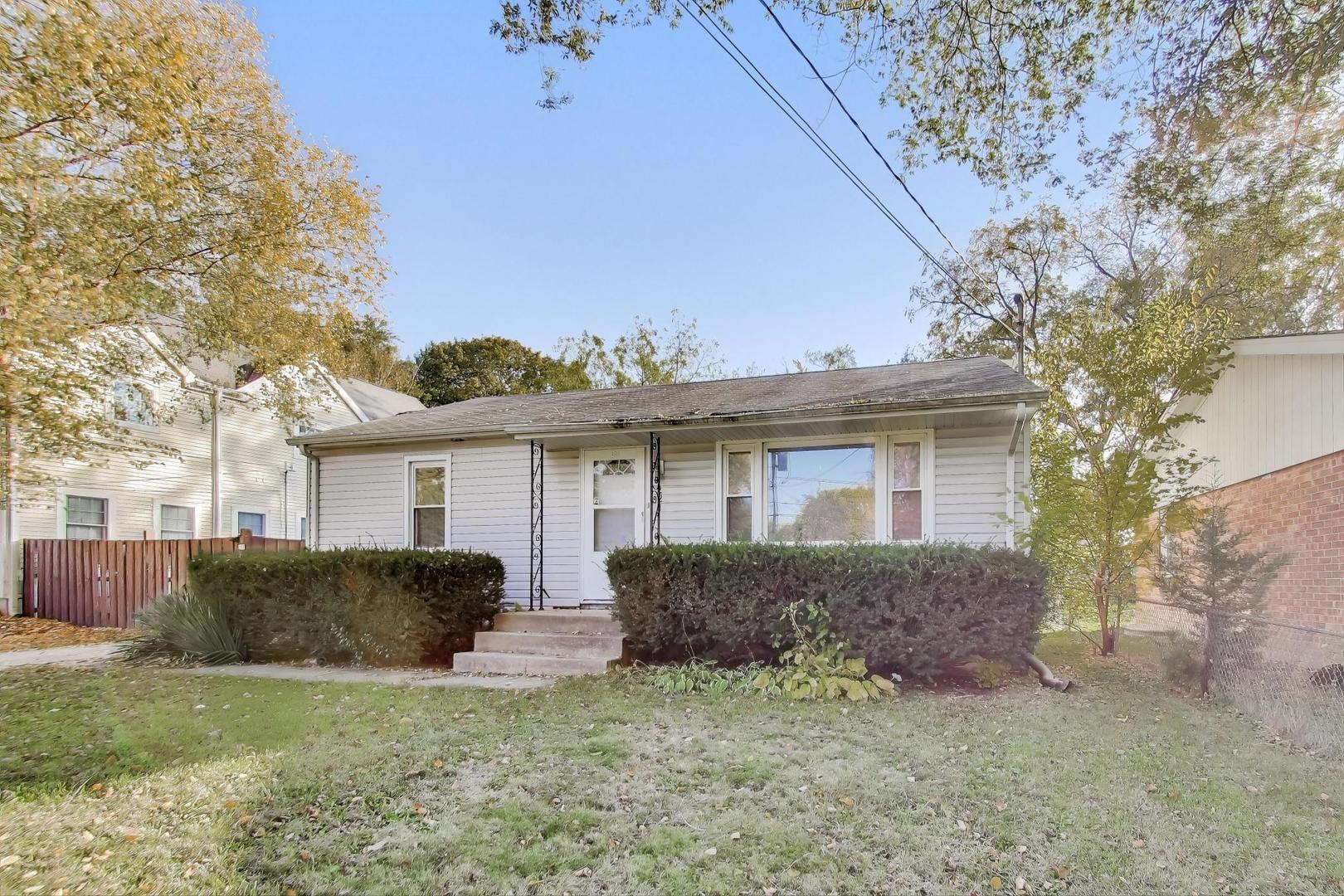 221 Heine Avenue Elgin, IL 60123 - Photo 3 of 43 a view of a yard in front of a house with large tree