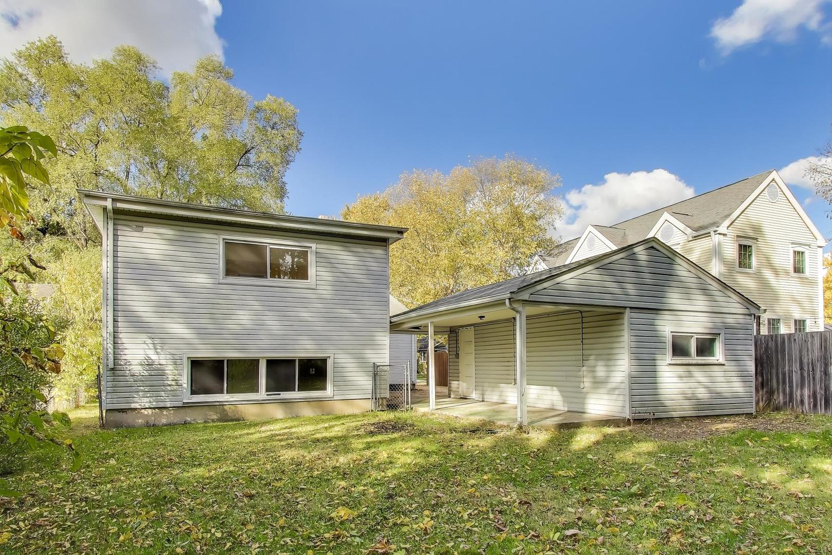 221 Heine Avenue Elgin, IL 60123 - Photo 32 of 43 a front view of a house with a garden