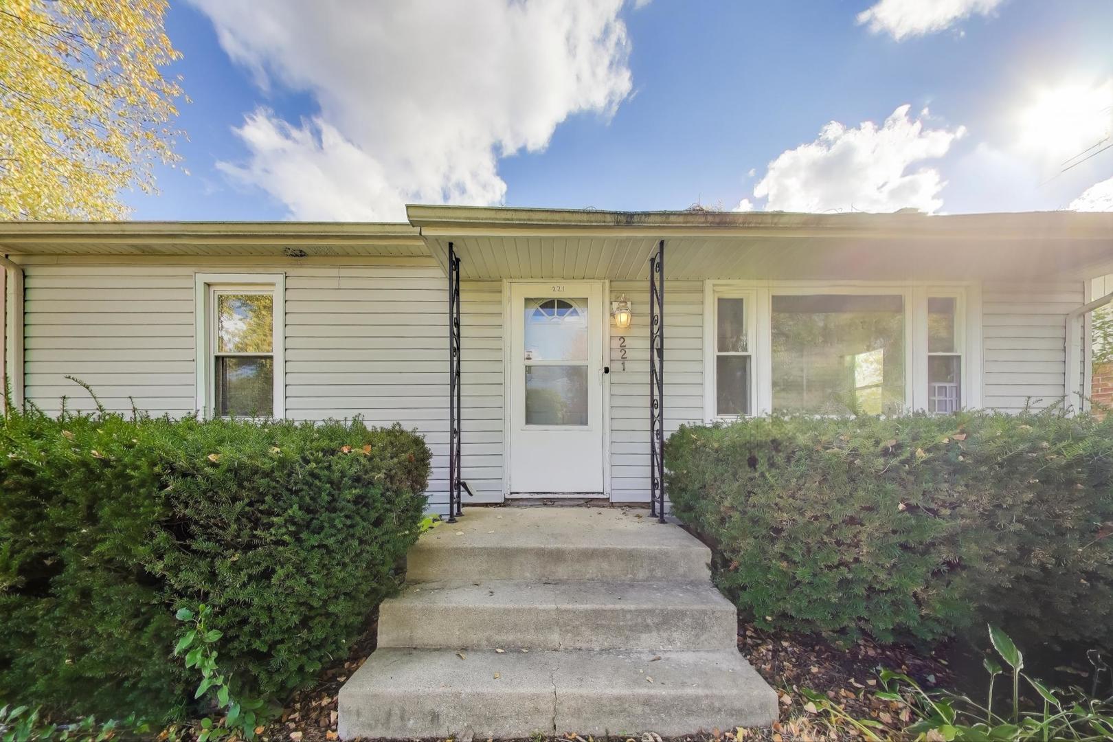 221 Heine Avenue Elgin, IL 60123 - Photo 7 of 43 a view of a house with large windows and plants