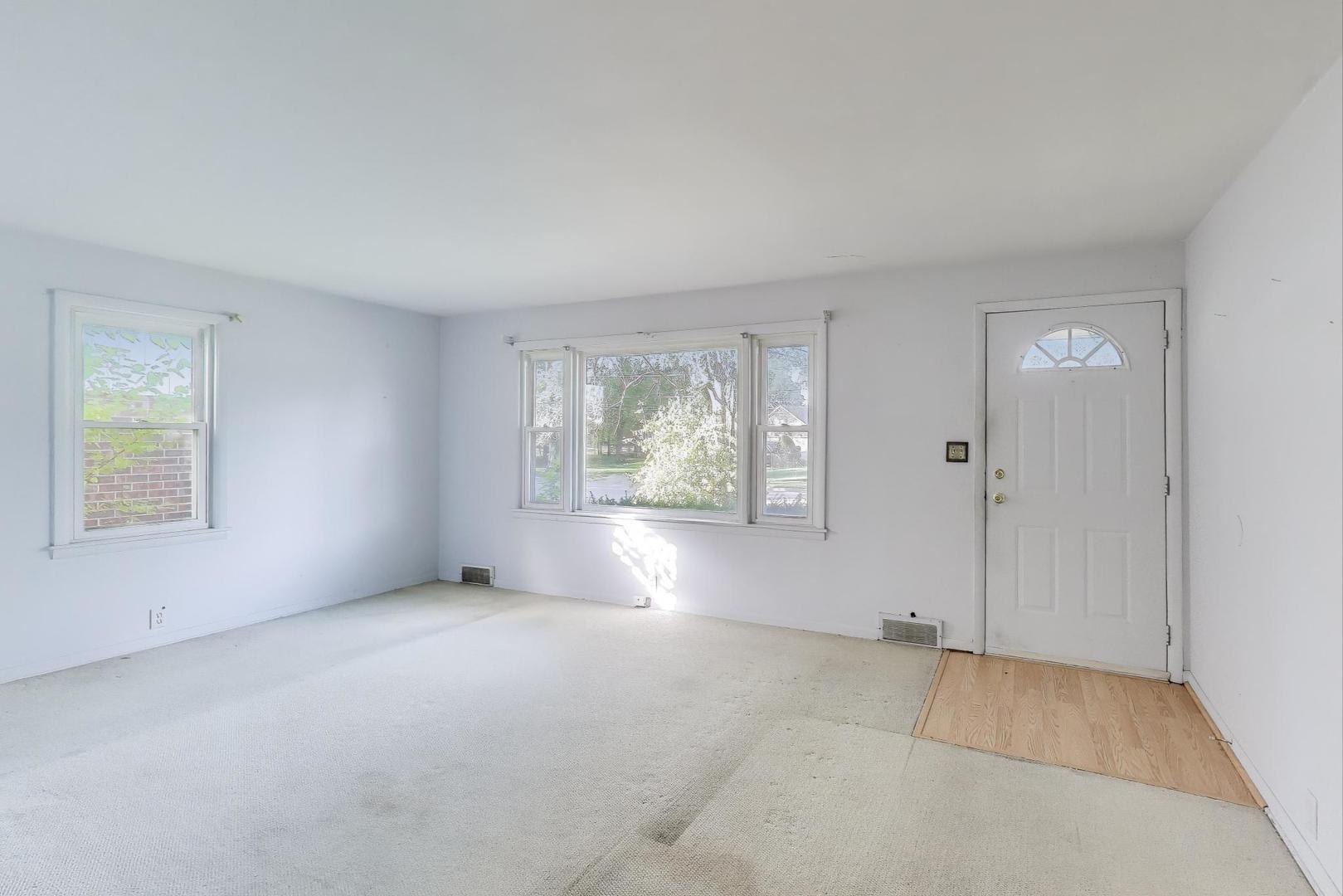 221 Heine Avenue Elgin, IL 60123 - Photo 9 of 43 an empty room with windows