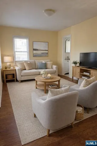 a living room with furniture and a flat screen tv