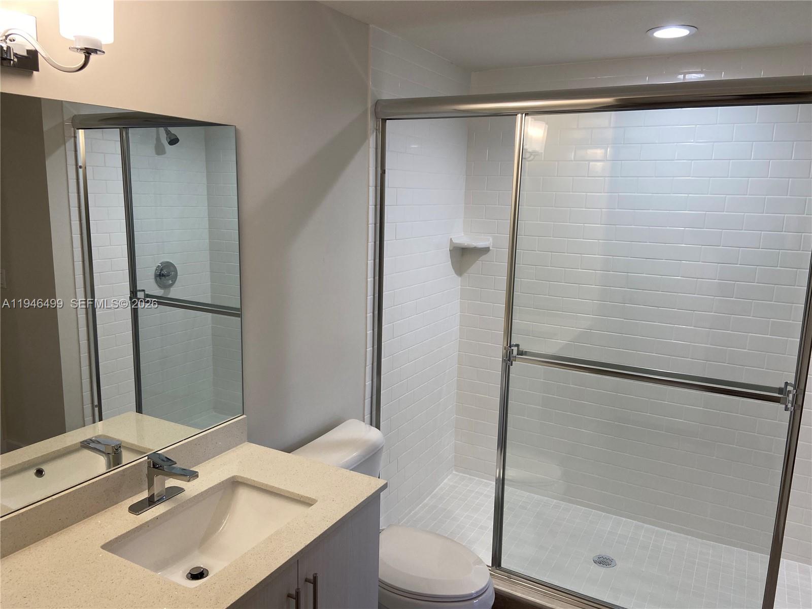 26511 Southwest 146th Court, Unit 216 Homestead, FL 33032 - Photo 5 of 6 a bathroom with a sink toilet and shower