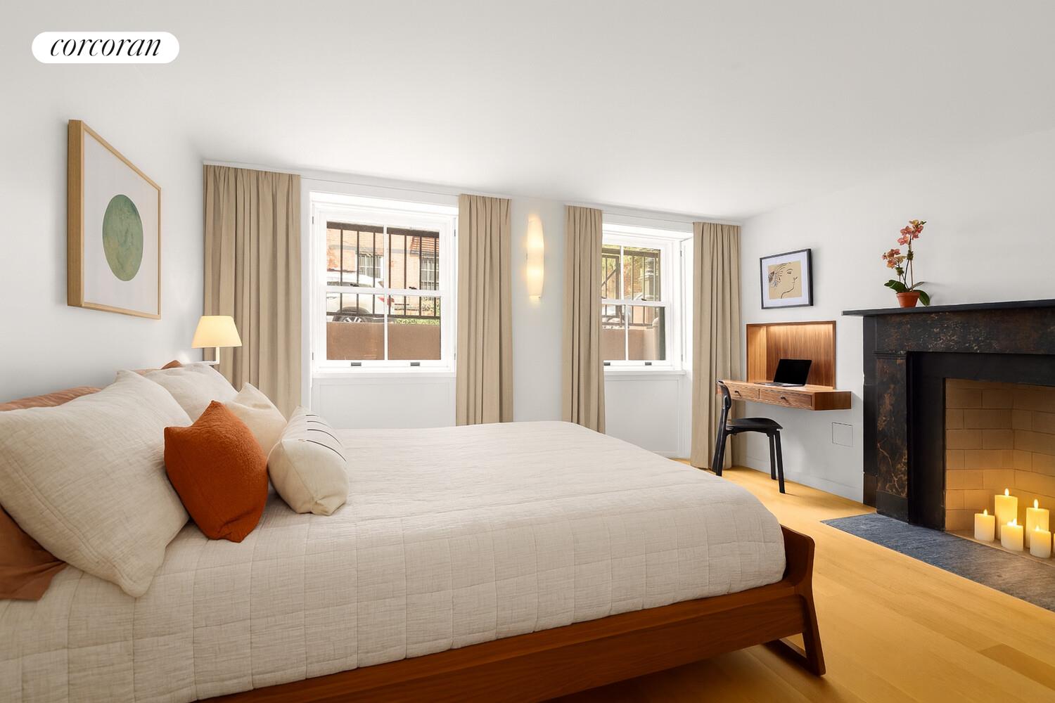 21 Bethune Street, Unit GARDEN Manhattan, NY 10014 - Photo 3 of 8 a bedroom with a bed and wooden floor