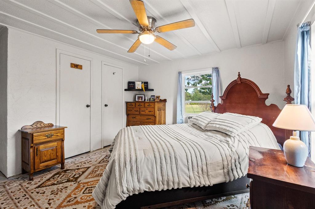 489 Delphia Drive Denison, TX 75021 - Photo 21 of 40 a bedroom with a bed and dresser