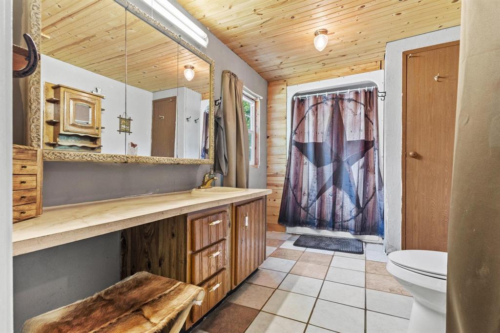 489 Delphia Drive Denison, TX 75021 - Photo 23 of 40 a bathroom with a sink a toilet and shower