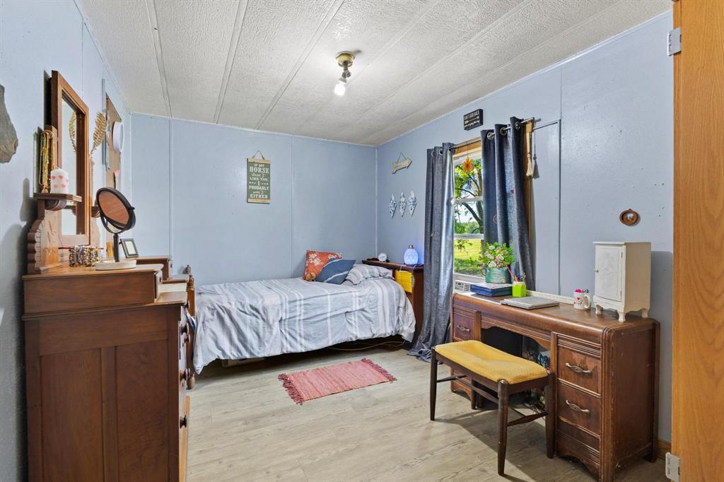 489 Delphia Drive Denison, TX 75021 - Photo 26 of 40 a bedroom with furniture and a window