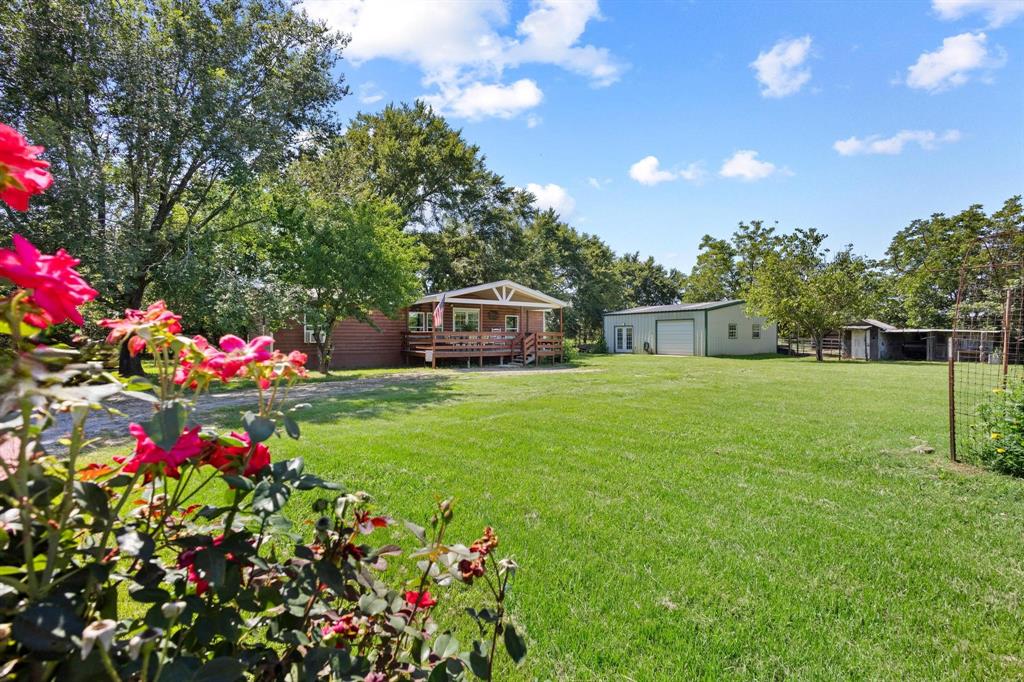 489 Delphia Drive Denison, TX 75021 - Photo 3 of 40 a front view of a house with a big yard and fountain