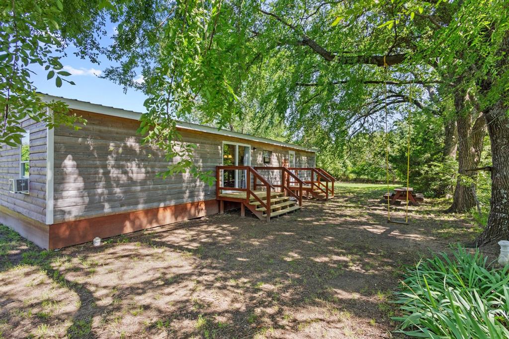 489 Delphia Drive Denison, TX 75021 - Photo 33 of 40 a view of a wooden deck with a yard