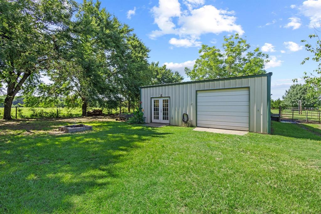 489 Delphia Drive Denison, TX 75021 - Photo 36 of 40 a view of a backyard with large trees