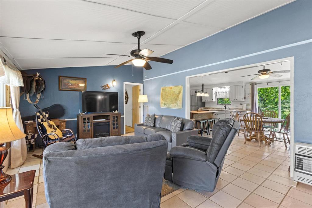489 Delphia Drive Denison, TX 75021 - Photo 9 of 40 a living room with furniture a flat screen tv and a window