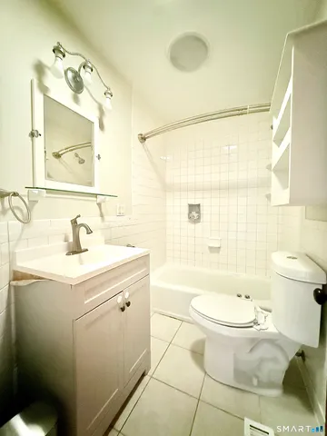 a view of a hallway with wooden floor and a living room