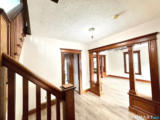 a view of an entryway with wooden floor