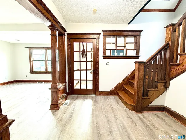 wooden floor in an empty room with a window