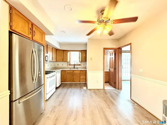 a kitchen with stainless steel appliances a refrigerator and a stove top oven