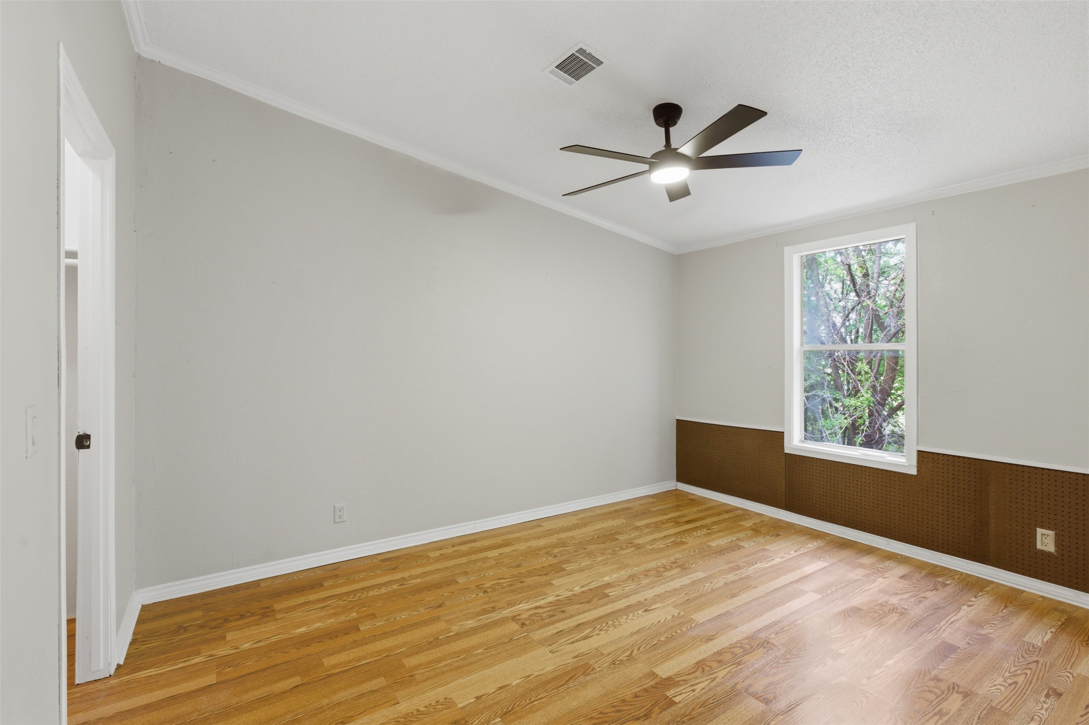 376 Rae Lane, Unit A Jarrell, TX 76537 - Photo 15 of 31 Hardwood-finish flooring complementing light wall tones, featuring a single window and crown molding