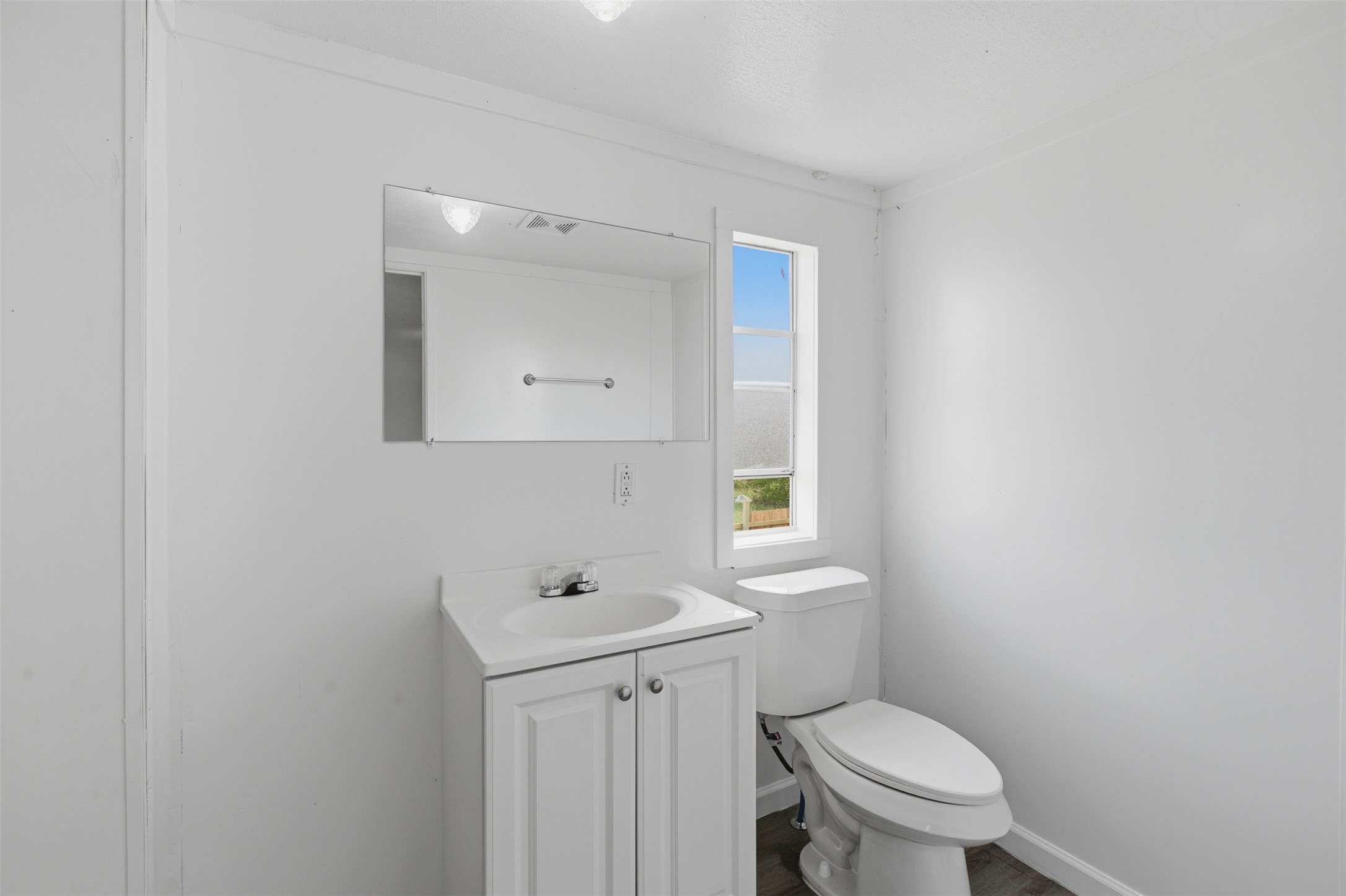 376 Rae Lane, Unit A Jarrell, TX 76537 - Photo 20 of 31 Bathroom featuring a vanity with shaker-style cabinetry, a white basin sink with a chrome faucet, and a wall-mounted mirror