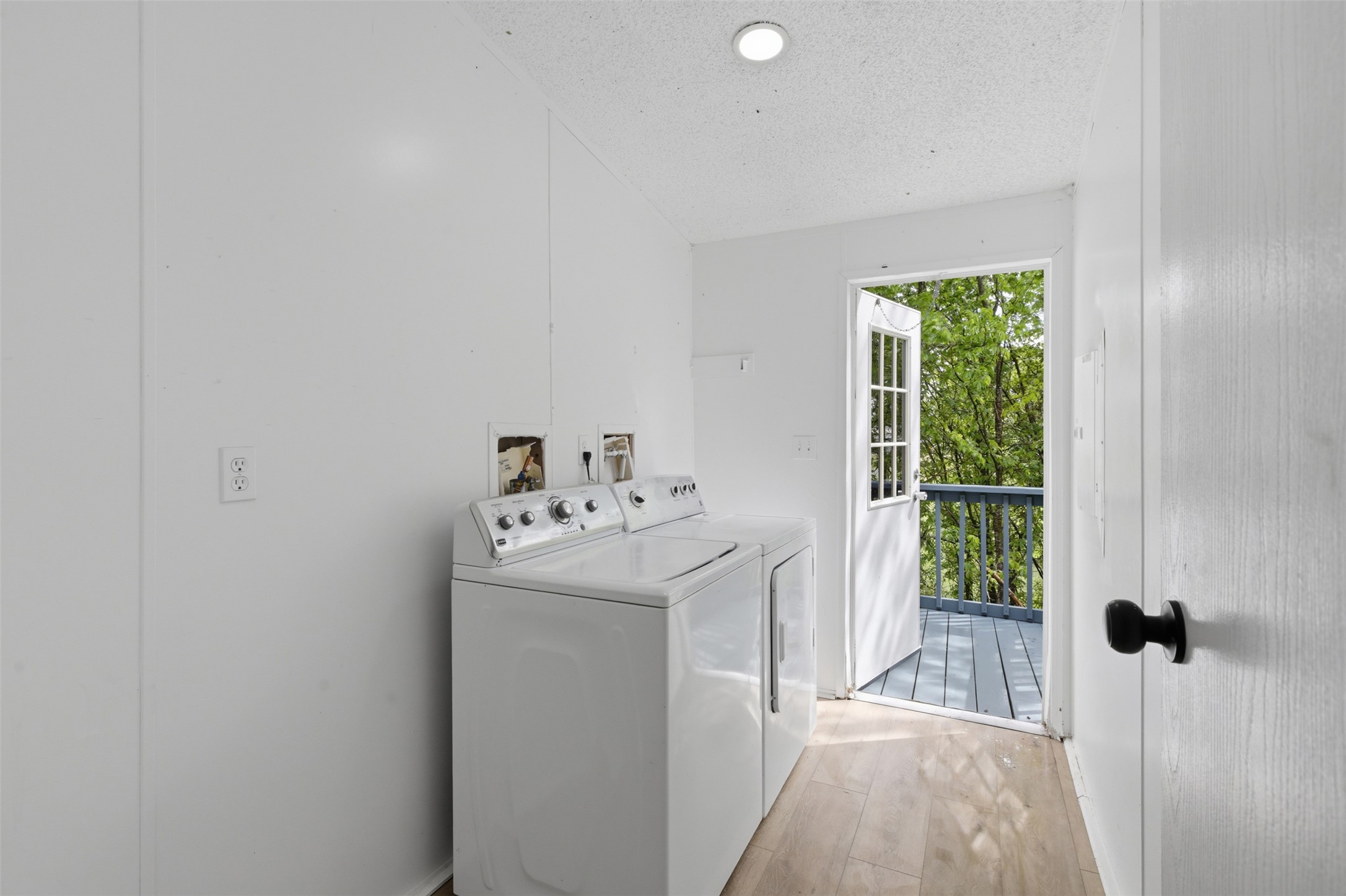 376 Rae Lane, Unit A Jarrell, TX 76537 - Photo 21 of 31 Laundry area featuring light wood-finish flooring, white paneled walls, and recessed lighting
