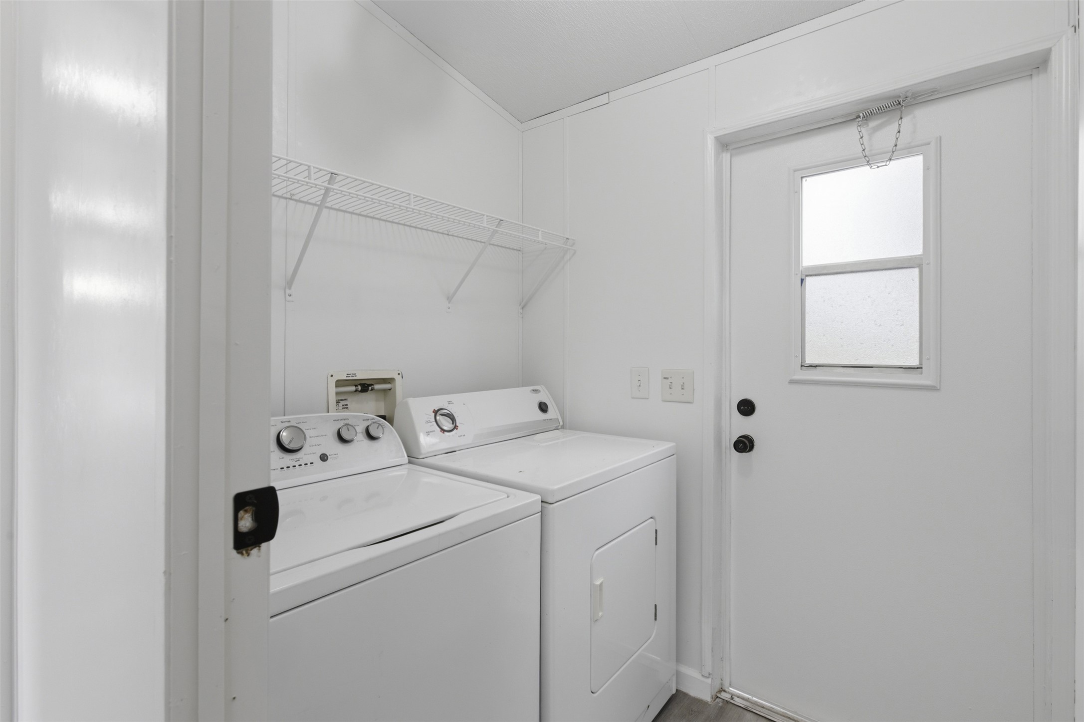 376 Rae Lane, Unit A Jarrell, TX 76537 - Photo 9 of 31 Dedicated laundry area featuring wire shelving and a rear exterior door