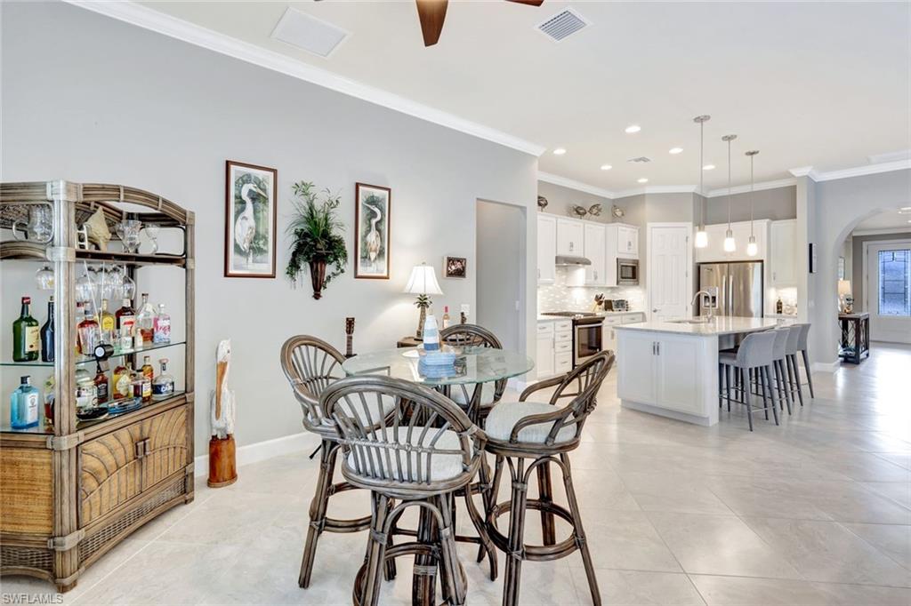 7451 Blackberry Drive Naples, FL 34114 - Photo 13 of 30 a view of a dining room with furniture