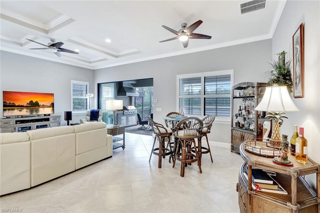 7451 Blackberry Drive Naples, FL 34114 - Photo 14 of 30 a living room with furniture and a flat screen tv