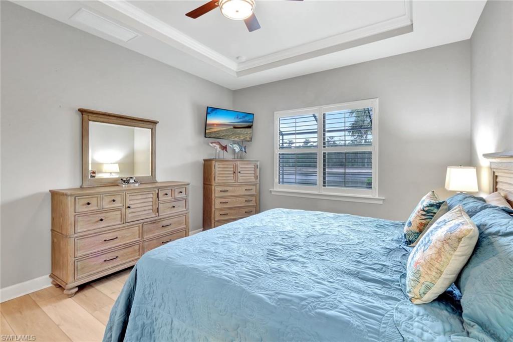 7451 Blackberry Drive Naples, FL 34114 - Photo 16 of 30 a bedroom with a bed and a dresser