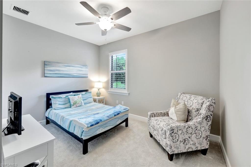 7451 Blackberry Drive Naples, FL 34114 - Photo 22 of 30 a bedroom with a bed and a couch