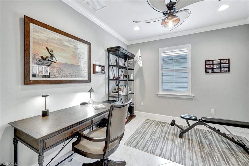 7451 Blackberry Drive Naples, FL 34114 - Photo 23 of 30 a view of a workspace with furniture and a window