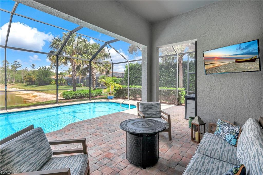 7451 Blackberry Drive Naples, FL 34114 - Photo 25 of 30 a living room with furniture and a floor to ceiling window