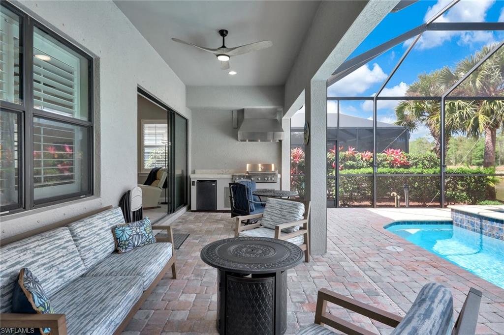 7451 Blackberry Drive Naples, FL 34114 - Photo 26 of 30 a lobby with furniture and a floor to ceiling window