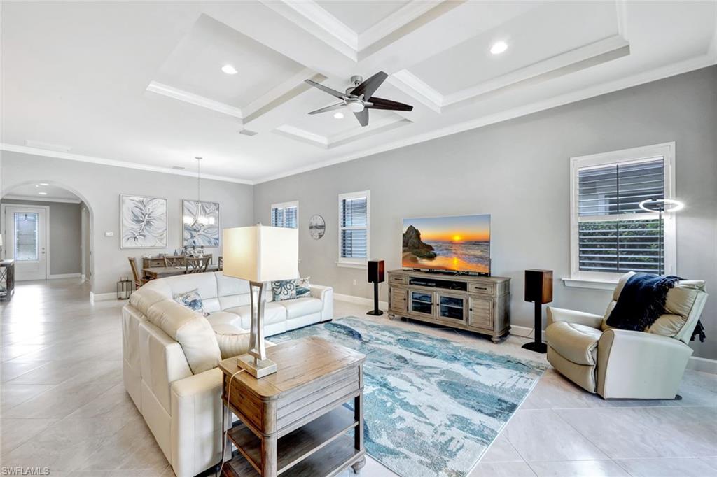 7451 Blackberry Drive Naples, FL 34114 - Photo 5 of 30 a living room with furniture and a flat screen tv