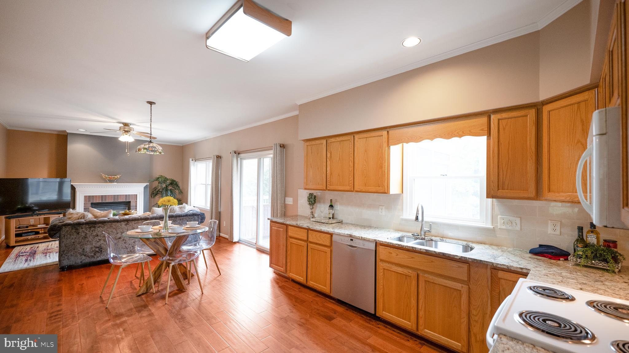 2826 Gracefield Road Silver Spring, MD 20904 - Photo 10 of 40 a kitchen with a sink a counter top space appliances and a window