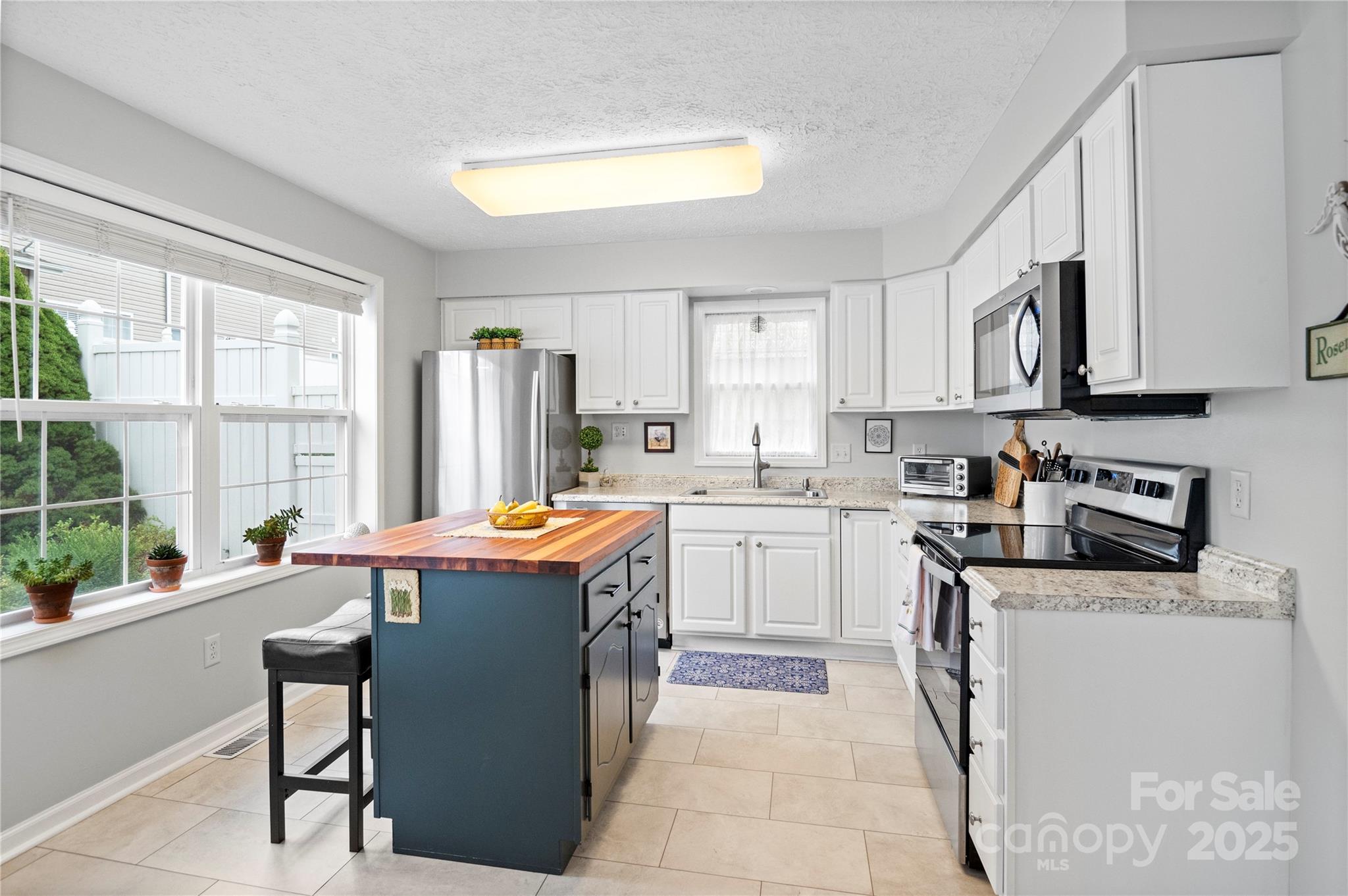 204 Pembrook Road Swannanoa, NC 28778 - Photo 3 of 15 a kitchen with a stove a sink a refrigerator and a window