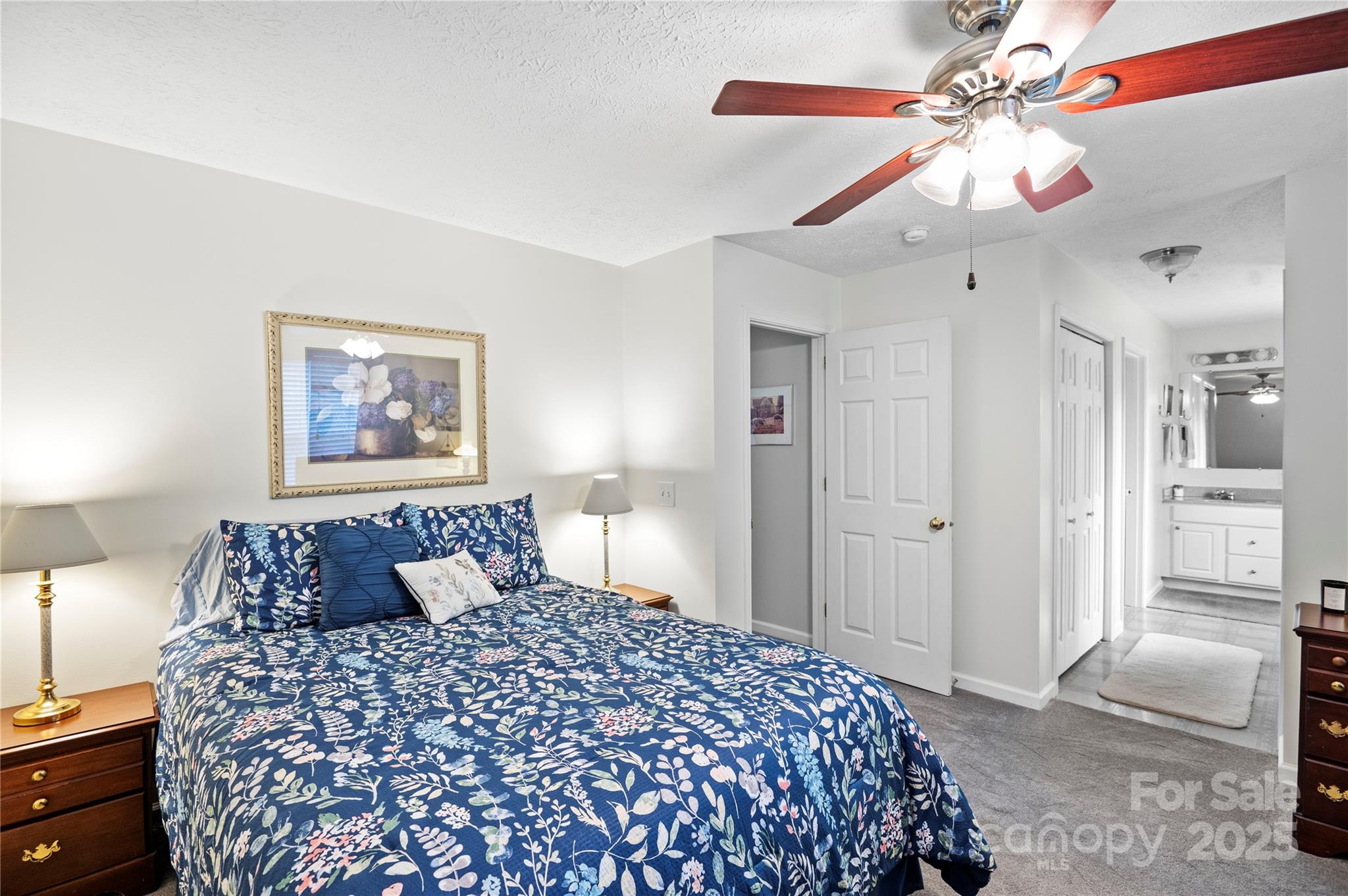 204 Pembrook Road Swannanoa, NC 28778 - Photo 7 of 15 a bedroom with a large bed and a chandelier