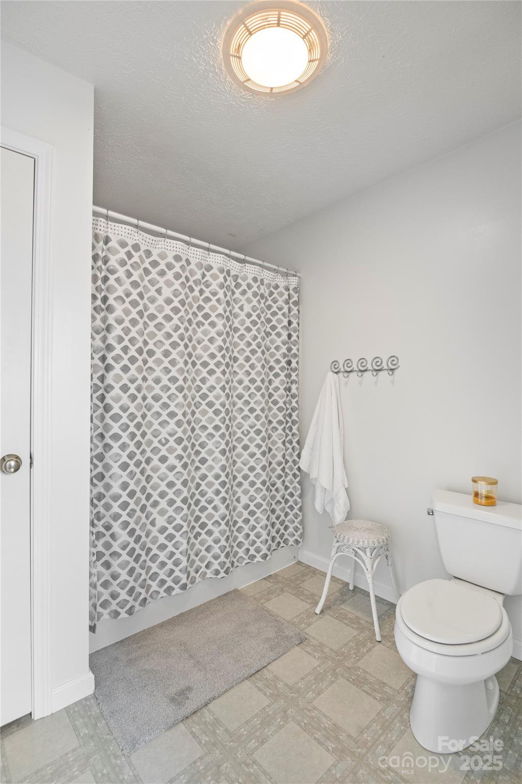 204 Pembrook Road Swannanoa, NC 28778 - Photo 9 of 15 a bathroom with a toilet and a shower curtain