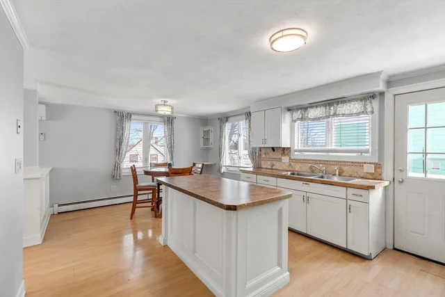 a kitchen with stainless steel appliances granite countertop a sink stove and wooden floor