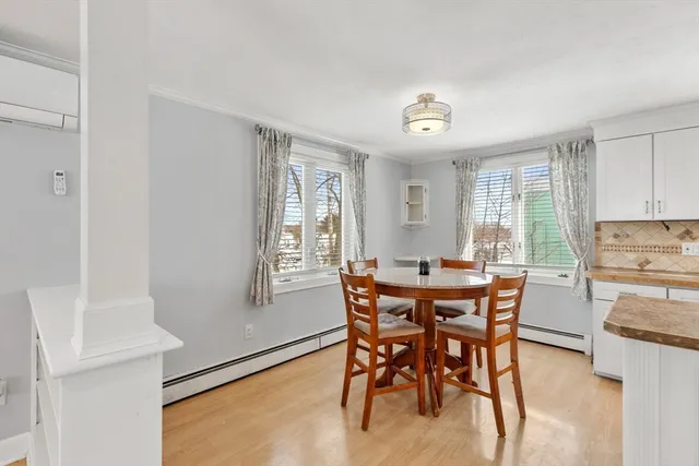 a view of a dining room with furniture and a window