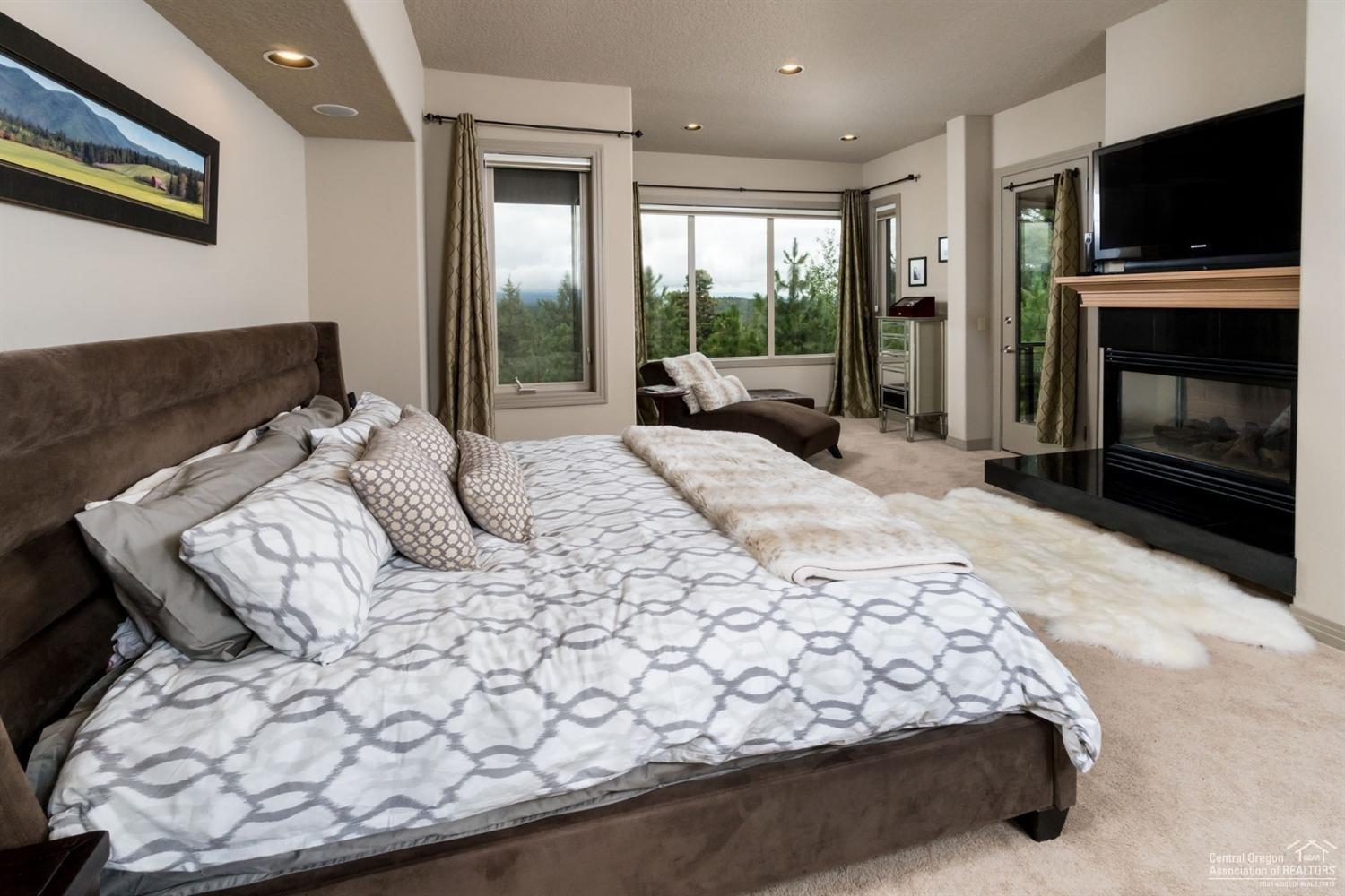 3155 Northwest Metke Place Bend, OR 97703 - Photo 14 of 22 Master bedroom with fireplace and privat