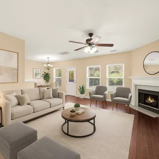 a view of a livingroom with a window and wooden floor
