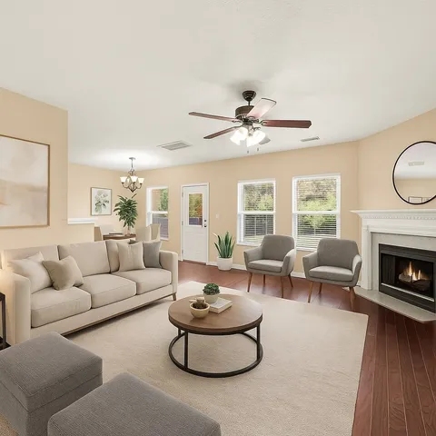 a view of a livingroom with a window and wooden floor