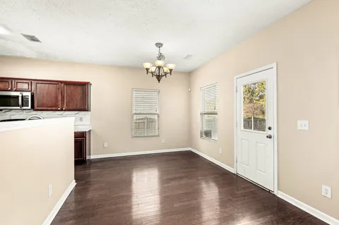 a kitchen with stainless steel appliances granite countertop a sink stove microwave and refrigerator