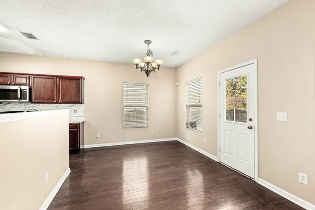 a kitchen with stainless steel appliances granite countertop a sink stove microwave and refrigerator